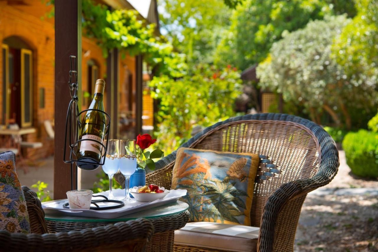 Garden pathway and pool area at Quartz Reef Motel surrounded by heritage fruit trees